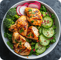 A bowl of grilled chicken, cucumber, radish and greens